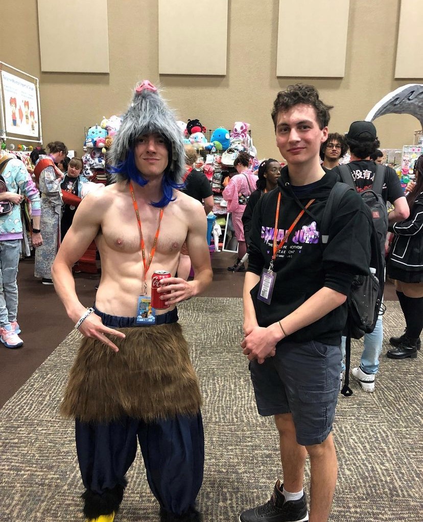 Cosplayer dressed as Hashibira Inosuke (from Demon Slayer) and my son at Colossal Con.